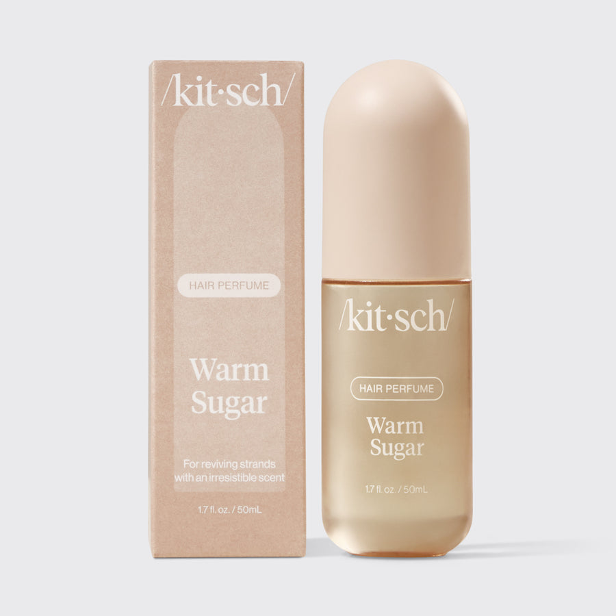 Kitsch Warm Sugar Hair & Body Perfume Mist bottle on a soft pink background