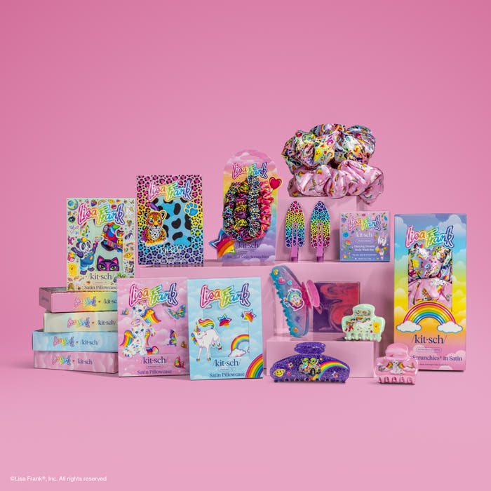 Lisa Frank x KITSCH hair accessories collection featuring scrunchies, claw clips, and bobby pins in rainbow, leopard, unicorn, and tie-dye prints, displayed on a pink background
