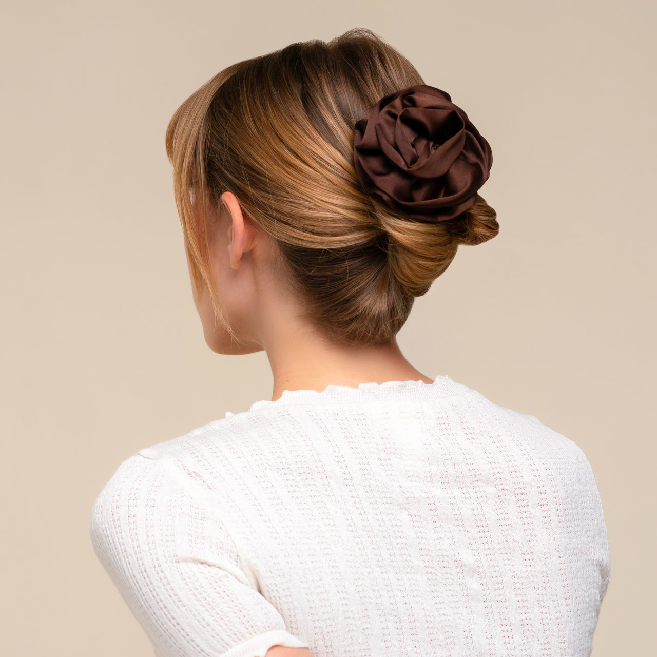 Person wearing the Satin Rosette Medium Flat Cloud Clip in Chocolate in their hair for an elegant updo
