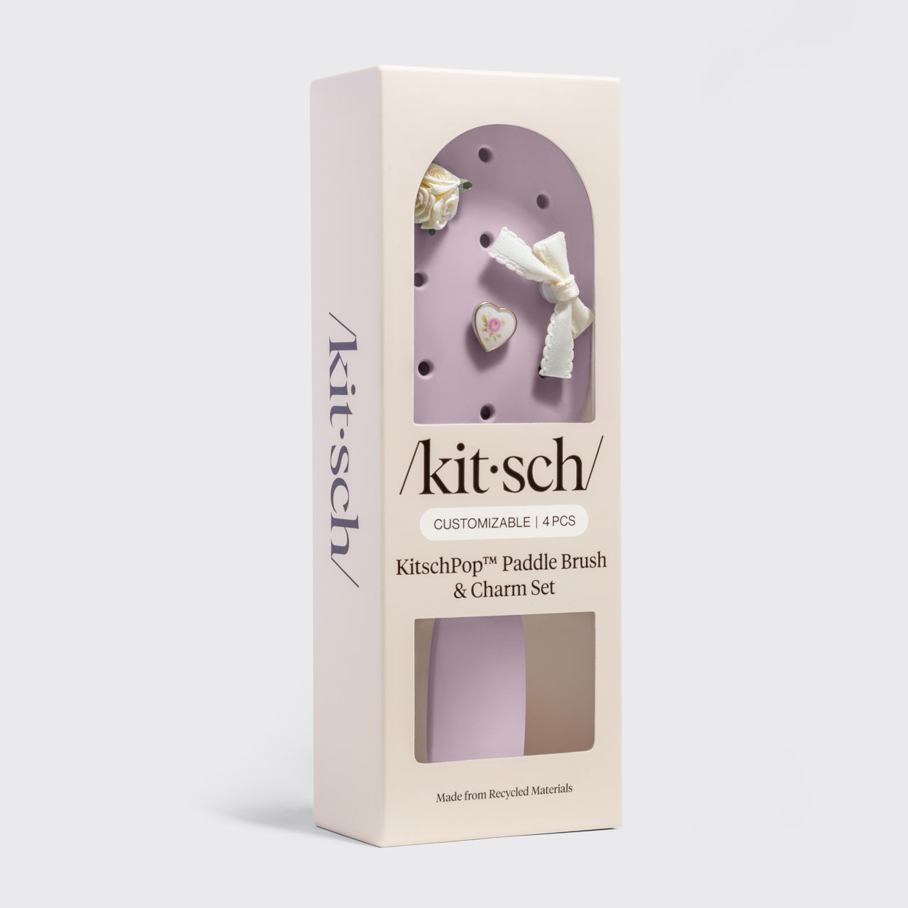 Kitsch paddle brush and charm set packaging on a light gray background