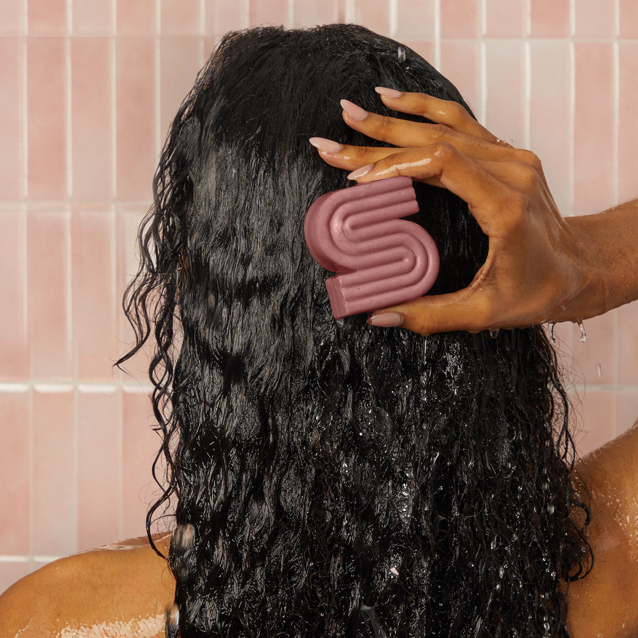 Lifestyle shot of Kitsch Castor Oil Nourishing Shampoo & Conditioner Bar Combo set styled in a warm bathroom scene