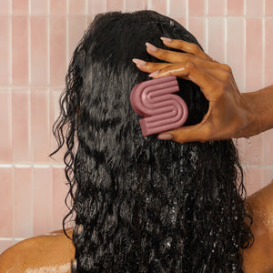 Lifestyle shot of Kitsch Castor Oil Nourishing Shampoo & Conditioner Bar Combo set styled in a warm bathroom scene