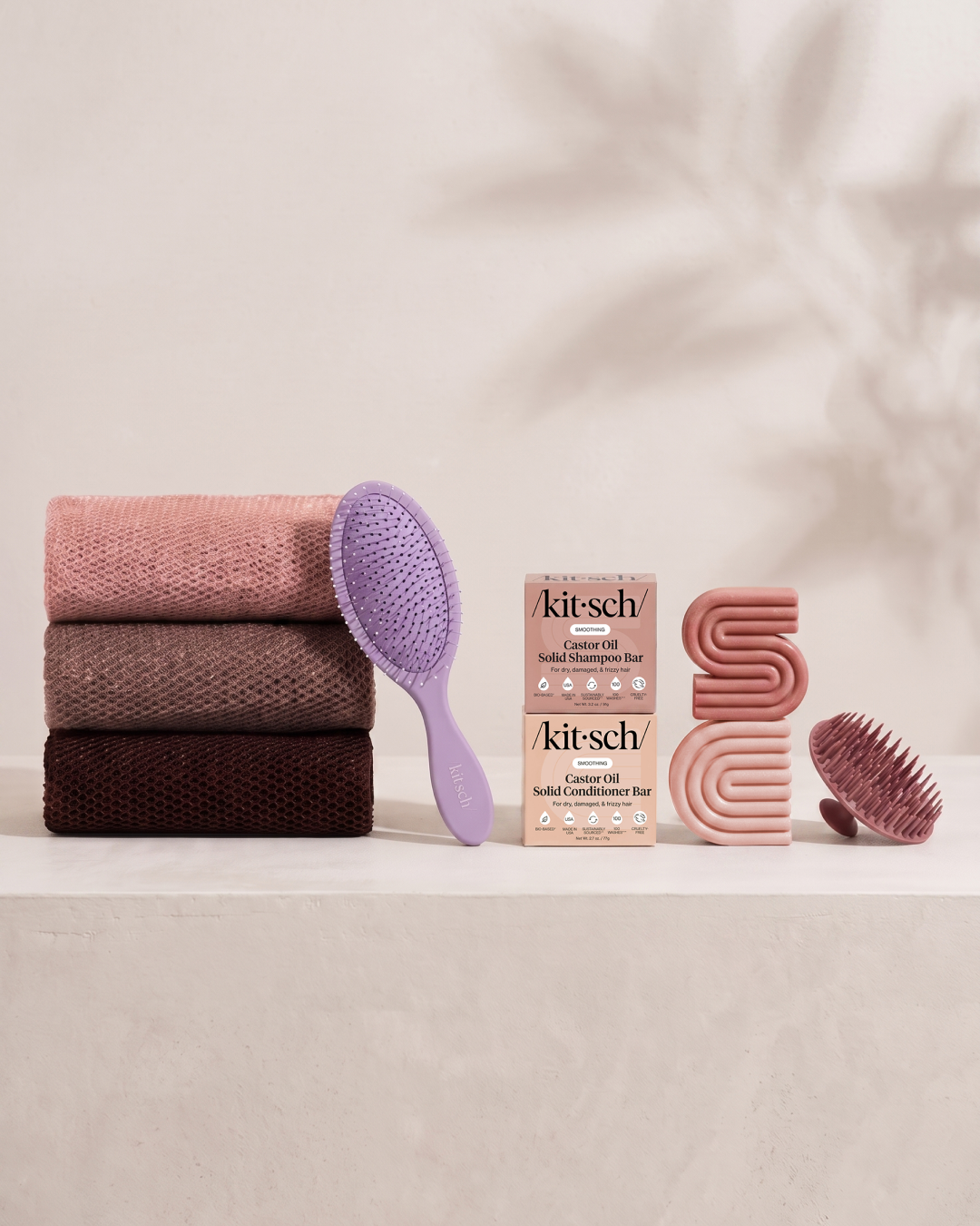 Kitsch Spring Welcome Kit Castor Oil shown as a full bundle with the Nourishing Castor Oil Shampoo and Conditioner Bars, Soft Violet Wet/Dry Brush, Terracotta Scalp Exfoliator and Rosewood African Net Sponge on a soft neutral background