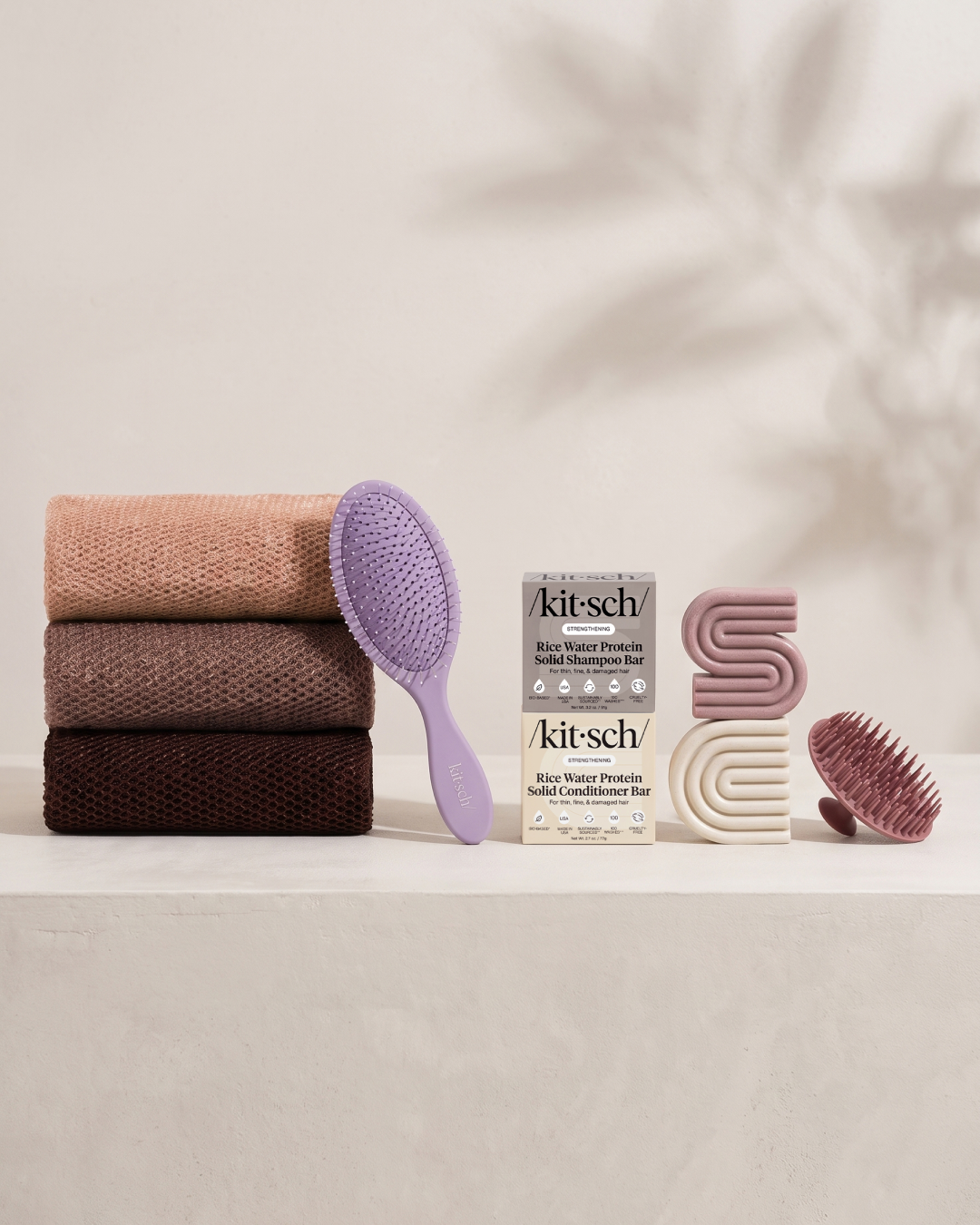 Kitsch Spring Welcome Kit Rice Water shown as a full bundle with the Strengthening Rice Water Shampoo and Conditioner Bars, Soft Violet Wet/Dry Brush, Terracotta Scalp Exfoliator and Rosewood African Net Sponge on a soft neutral background